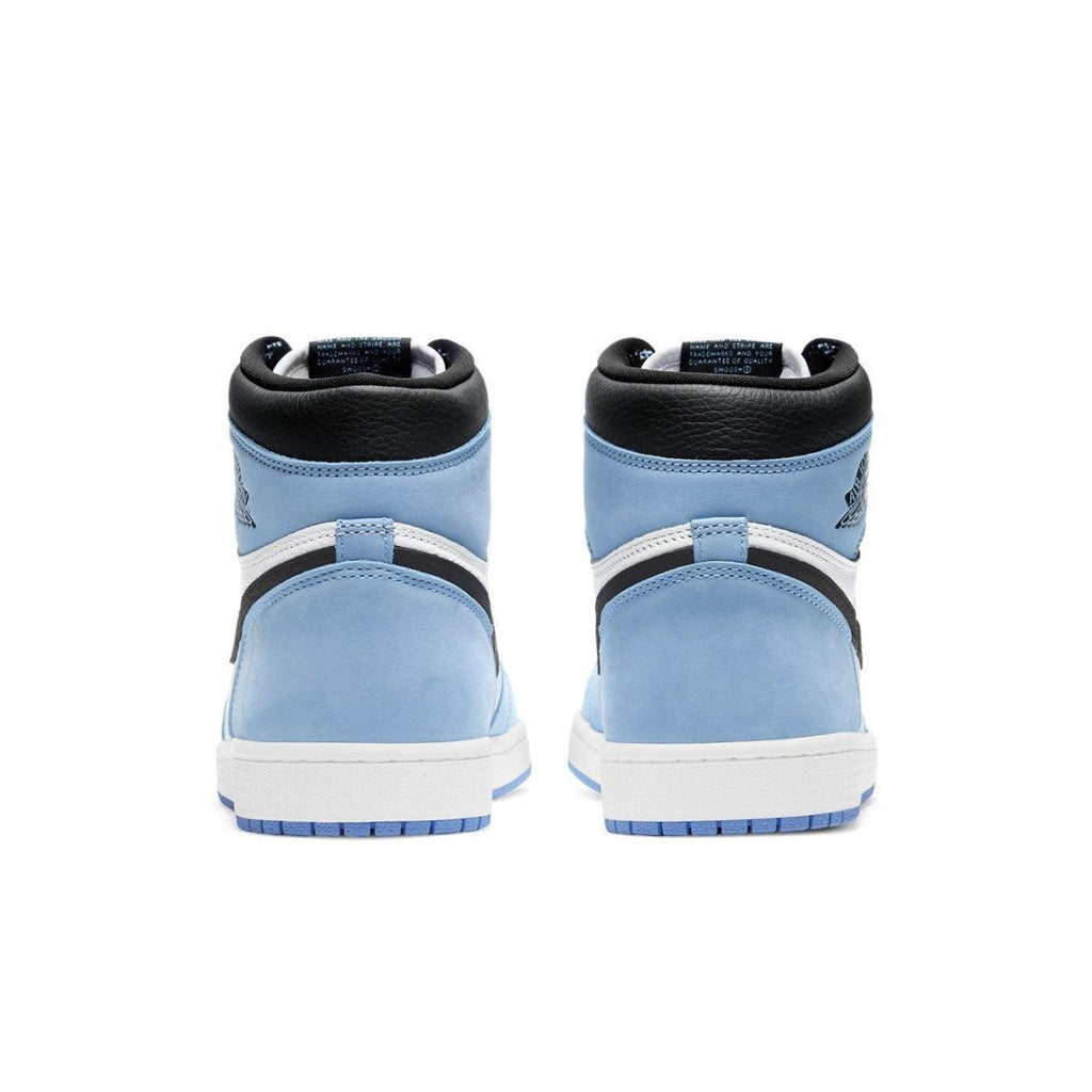 Rear view of Air Jordan 1 Retro High in white, university blue, and black, showcasing suede and leather details.