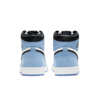 Rear view of Air Jordan 1 Retro High in white, university blue, and black, showcasing suede and leather details.