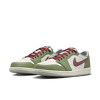 Jordan 1 Retro Low AJ1 sneaker in green and white with red accents and textured Swoosh logo.