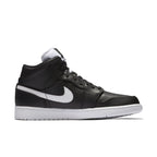 Air Jordan 1 Retro Mid Black and White sneaker with leather upper and signature Swoosh design.