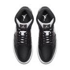 Top view of Air Jordan 1 Retro Mid Black White featuring black leather upper and white accents.