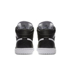 Back view of Jordan 1 Retro Mid Black White shoes showcasing sleek black leather and iconic Jumpman logo.