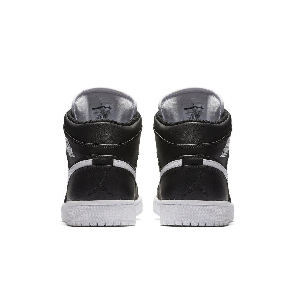 Back view of Jordan 1 Retro Mid Black White shoes showcasing sleek black leather and iconic Jumpman logo.