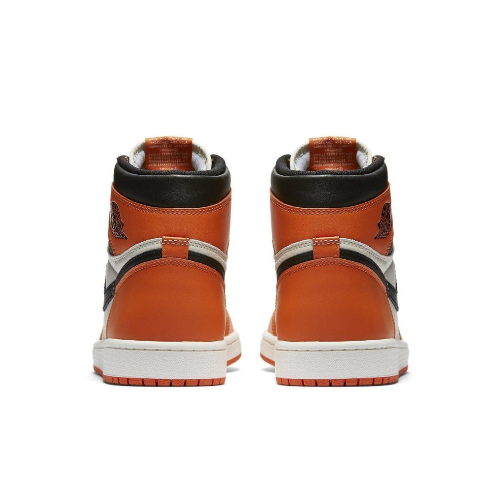 Back view of the Jordan 1 Retro Reverse Shattered Backboard sneakers in orange, black, and white.