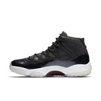 Air Jordan 11 Retro '72-10' shoes featuring black leather and patent detailing.