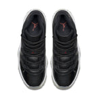 Top view of Air Jordan 11 Retro '72-10' sneakers featuring premium black leather and sleek design.