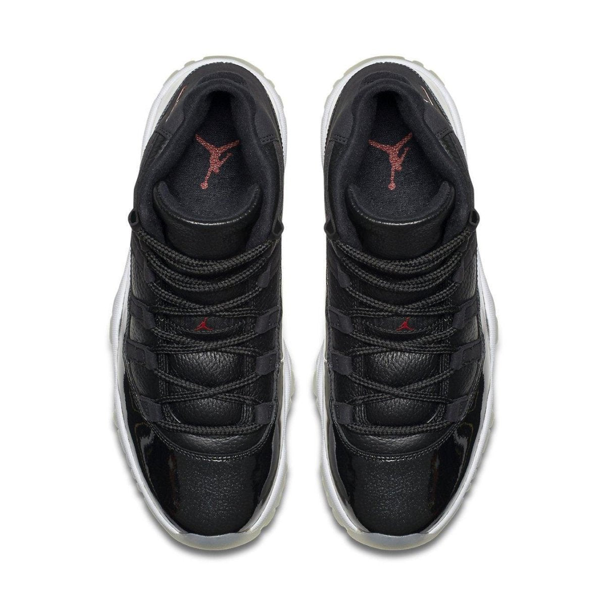 Top view of Air Jordan 11 Retro '72-10' sneakers featuring premium black leather and sleek design.