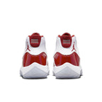 Rear view of Jordan 11 Retro 'Cherry' sneakers featuring a white upper and scarlet patent leather accents.