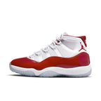 Air Jordan 11 Retro 'Cherry' sneakers in white and red colorway, featuring a glossy red patent leather and mesh upper.