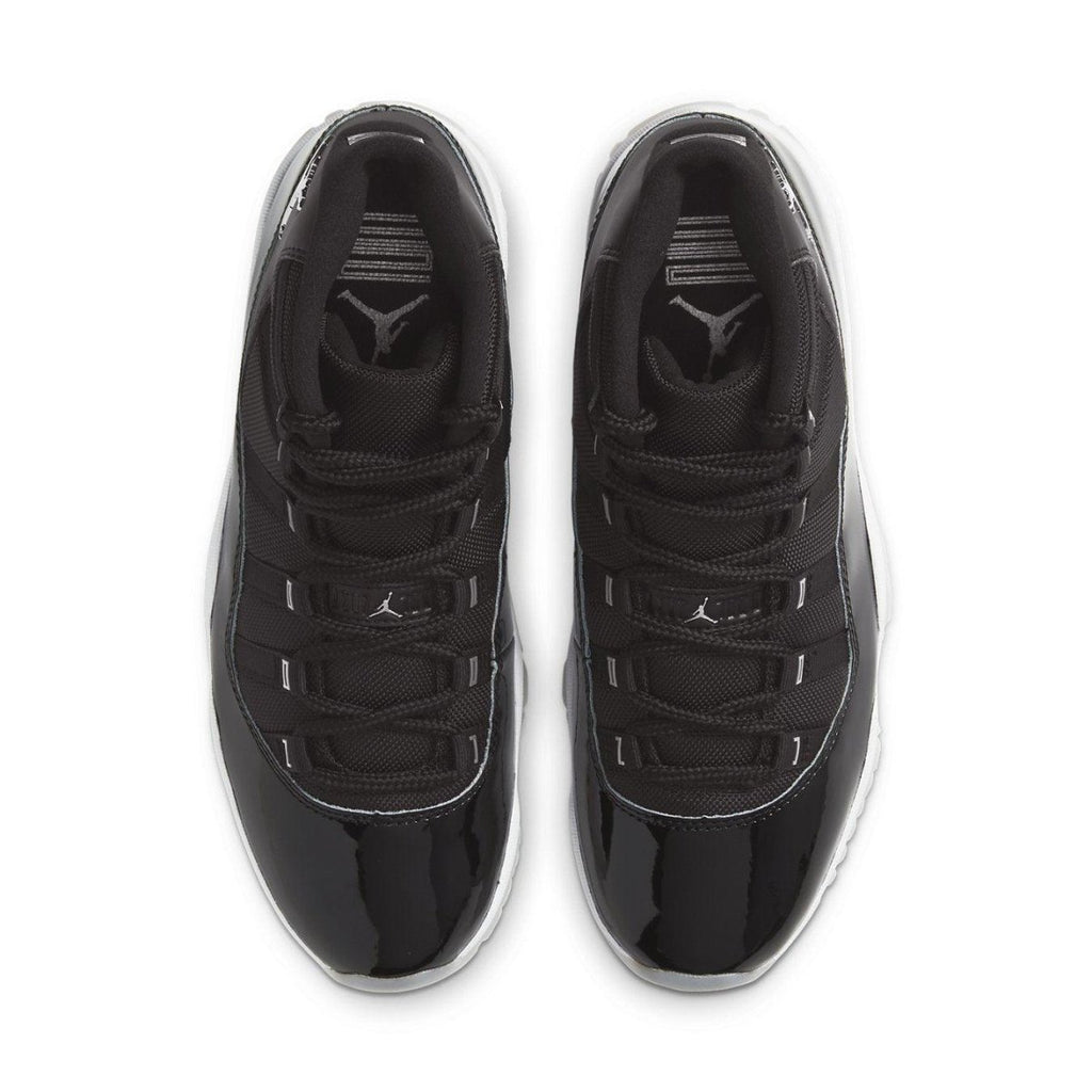 Top view of Air Jordan 11 Retro Jubilee 25th Anniversary sneakers in black with glossy detailing and Jordan logo.