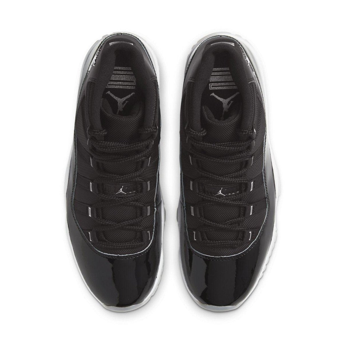 Top view of Air Jordan 11 Retro Jubilee 25th Anniversary sneakers in black with glossy detailing and Jordan logo.