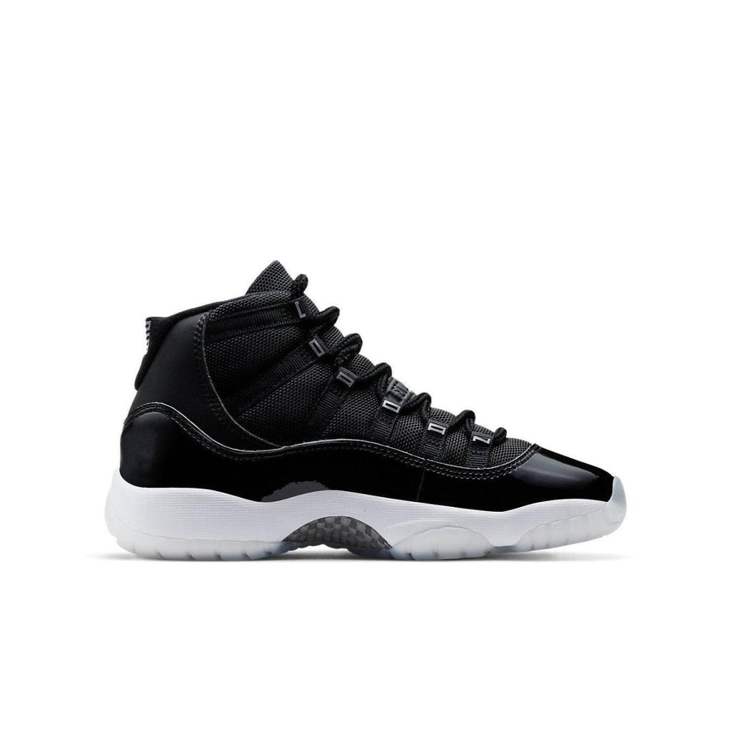 Jordan 11 Retro Jubilee (GS) in black and white with carbon fiber plate and patent leather finish.