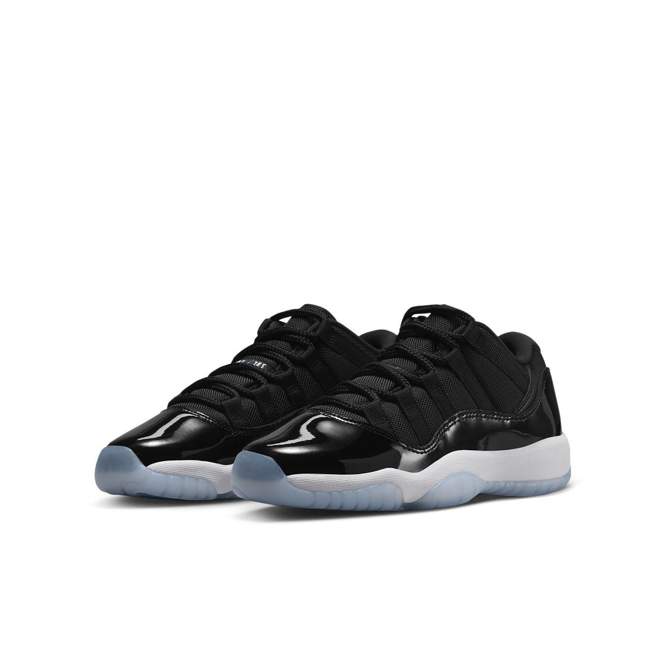 Air Jordan 11 Retro Low Space Jam (GS) sneakers in black and white with a sleek design and translucent sole.