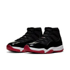Air Jordan 11 Retro 'Bred' 2019 sneakers featuring black mesh, patent leather, and a Varsity Red outsole.