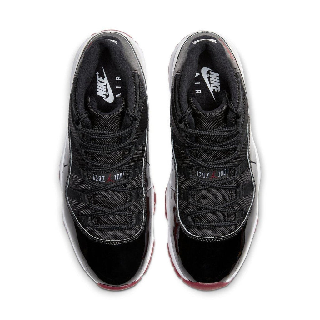 Air Jordan 11 Retro Bred 2019 top view showcasing black mesh and patent leather design with Varsity Red accents.