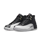 Jordan 12 Retro Playoffs 2022 sneaker in black and white with textured overlays and silver eyelets.