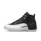 Air Jordan 12 Retro 'Playoff' 2022 sneaker in black and white with iconic design and silver eyelets.