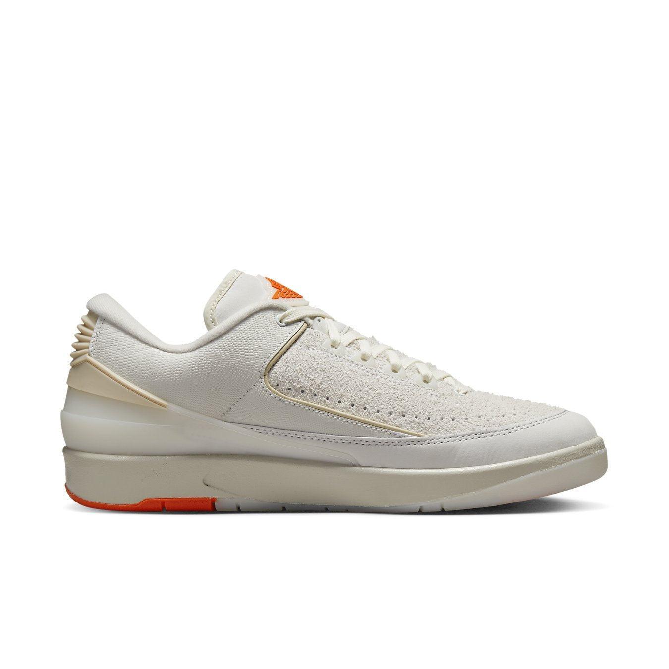Jordan 2 Retro Low Shelflife white sneaker profile view with orange accents
