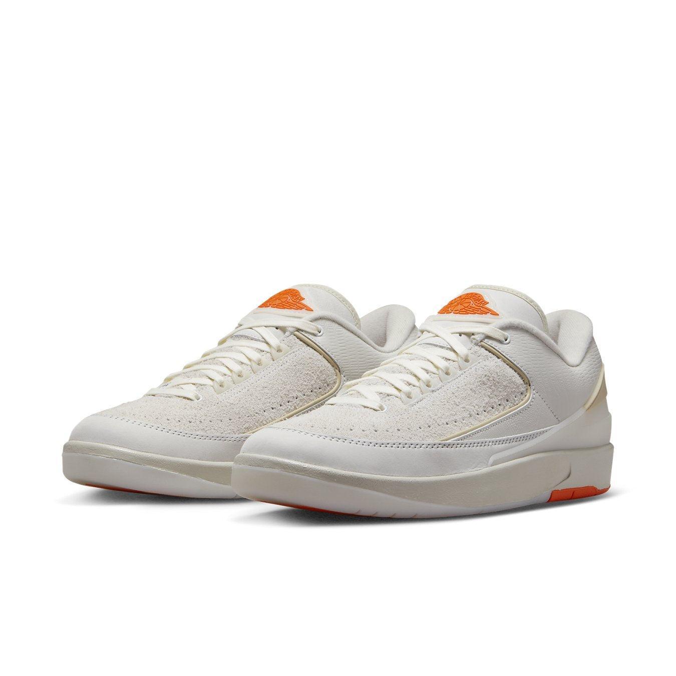 Jordan 2 Retro Low Shelflife sneakers in white with orange accents, showcasing a stylish and modern design.
