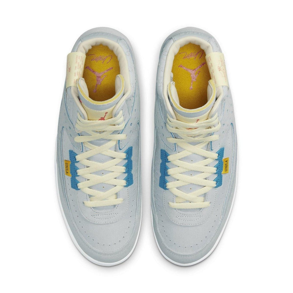 Air Jordan 2 Retro SP Union Grey Fog sneakers featuring blue and yellow accents and a light grey suede upper.