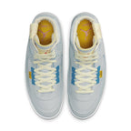 Air Jordan 2 Retro SP Union Grey Fog sneakers featuring blue and yellow accents and a light grey suede upper.