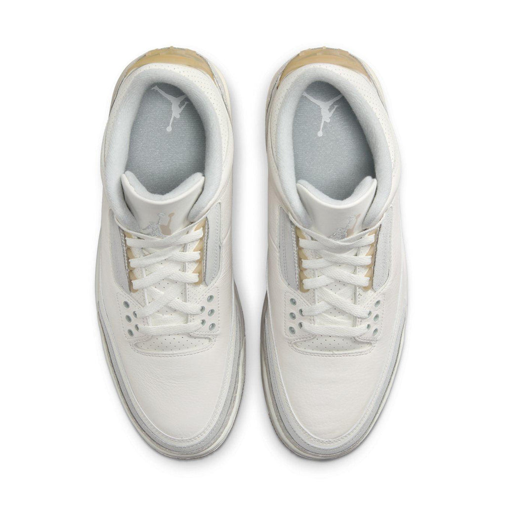 Top view of the Jordan 3 Retro Craft Ivory sneaker with sleek white leather and gold accents.