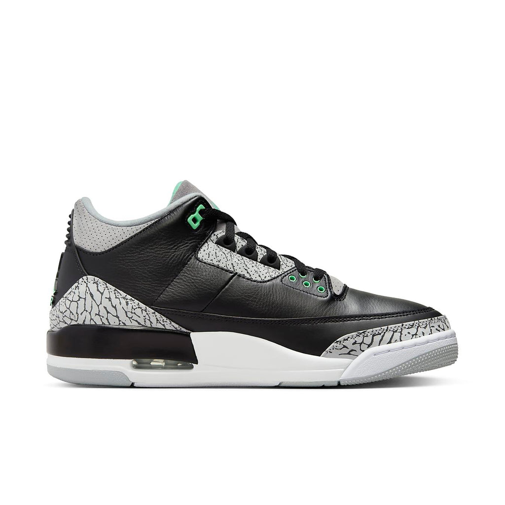 Jordan 3 Retro Green Glow sneakers featuring black leather upper with grey mesh and subtle green accents.