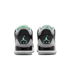 Rear view of Jordan 3 Retro Green Glow sneakers showcasing black leather and green accents.