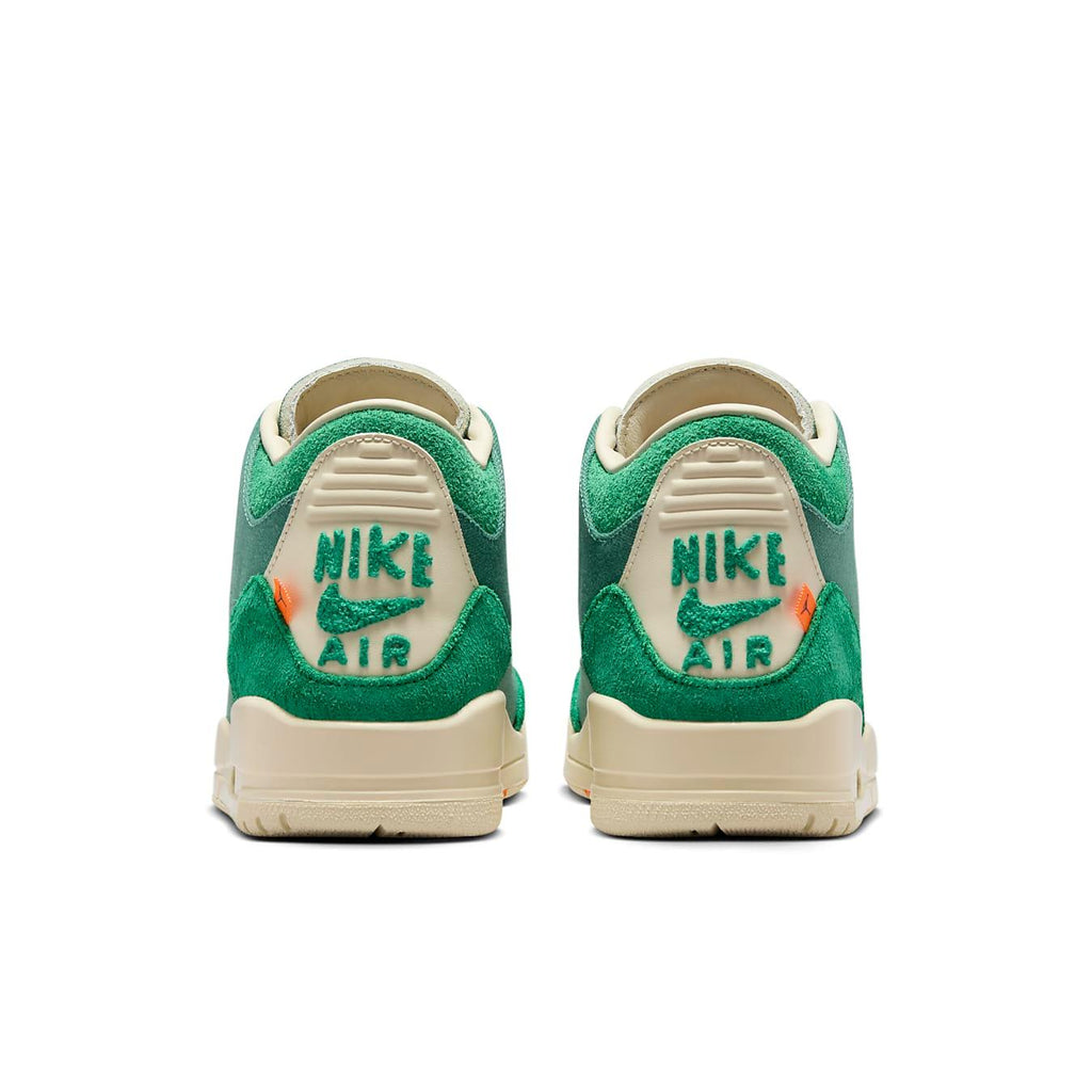 Nike Air sneakers featuring bold green colorway and contrasting 'Nike Air' branding on the heel supports.