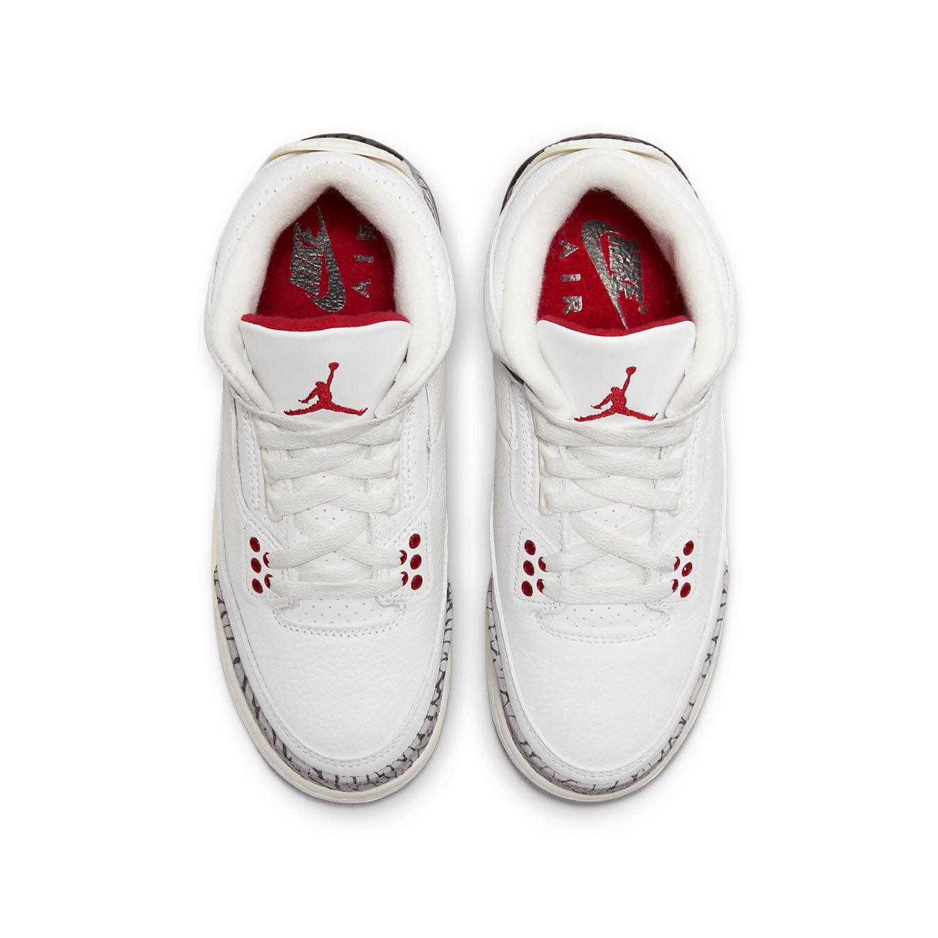 Top view of Air Jordan 3 Retro GS 'White Cement Reimagined' sneakers with white leather and red accents.