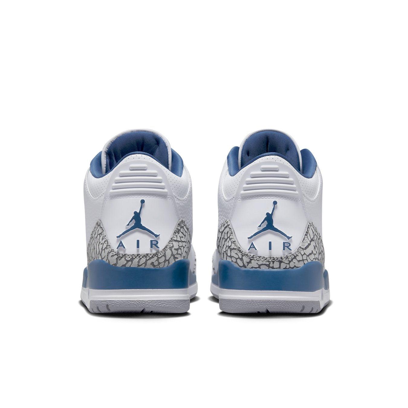Back view of Air Jordan 3 Retro Wizards featuring white upper, elephant print overlays, and blue accents.