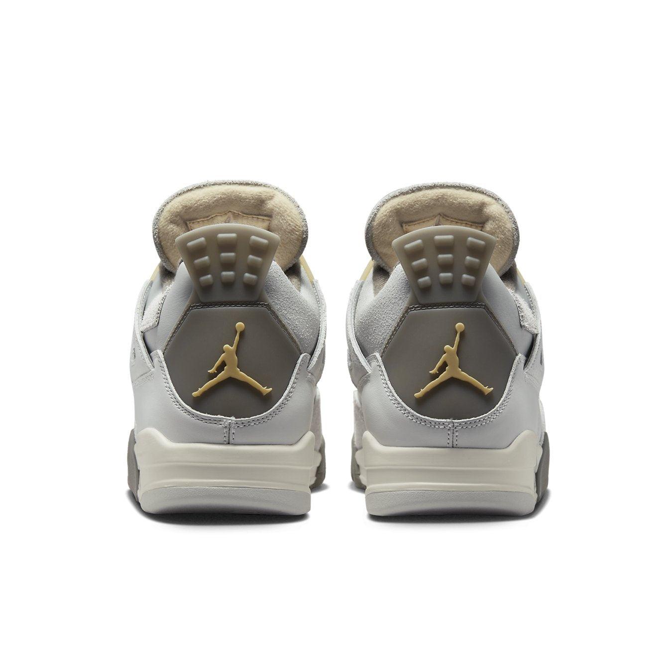 Air Jordan 4 Retro SE Craft Photon Dust shoes, showing light gray leather back view with gold accents.