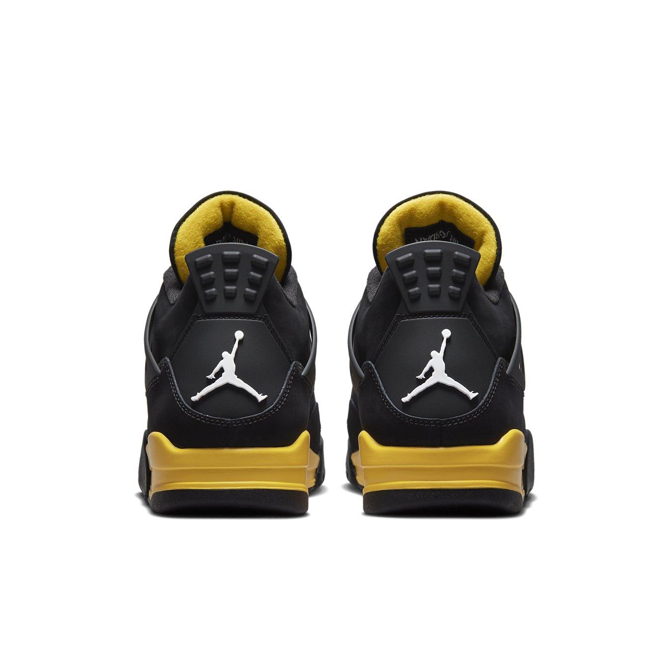 Rear view of Jordan 4 Retro Thunder 2023 sneakers showcasing black nubuck with yellow accents.