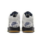 Back view of the women's Air Jordan 5 Retro A Ma Maniére Dawn sneakers featuring gray leather and navy accents.