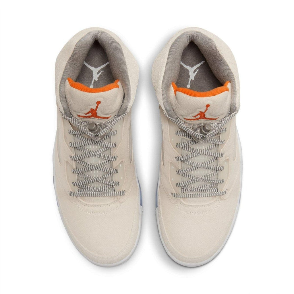 Top view of Jordan 5 Retro SE Craft Light Orewood Brown sneakers featuring beige suede and bright orange accents.