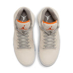 Top view of Jordan 5 Retro SE Craft Light Orewood Brown sneakers featuring beige suede and bright orange accents.