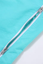 Close-up of mint green zip detail on Simba La Rue track pants, showcasing high-quality zipper and fabric texture.