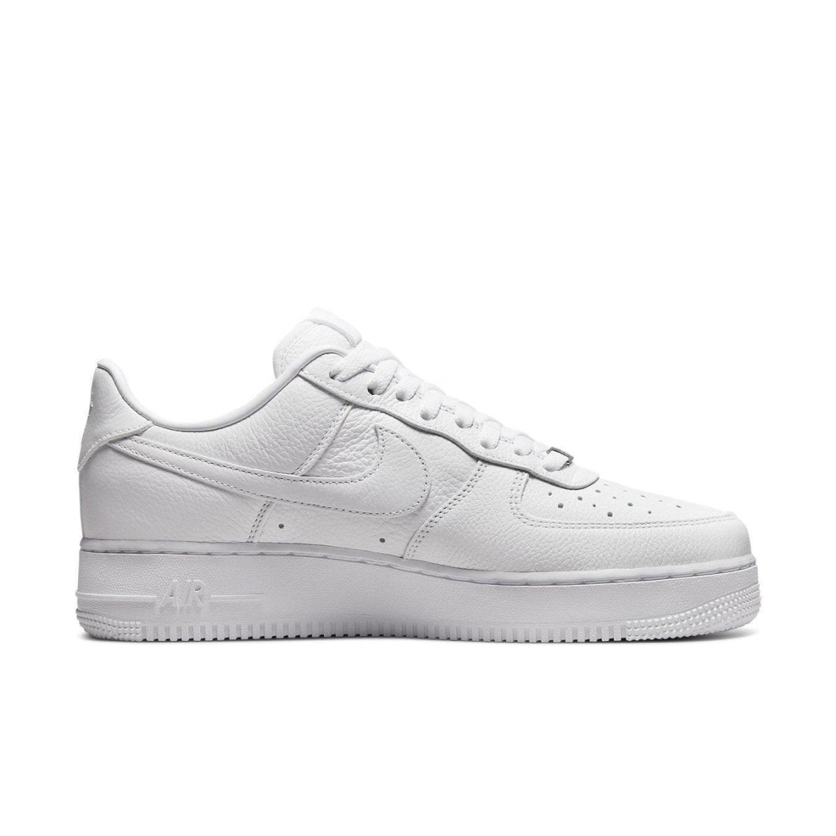 Nike Air Force 1 Low in all-white leather, featuring a tonal Swoosh and classic perforated toe box.