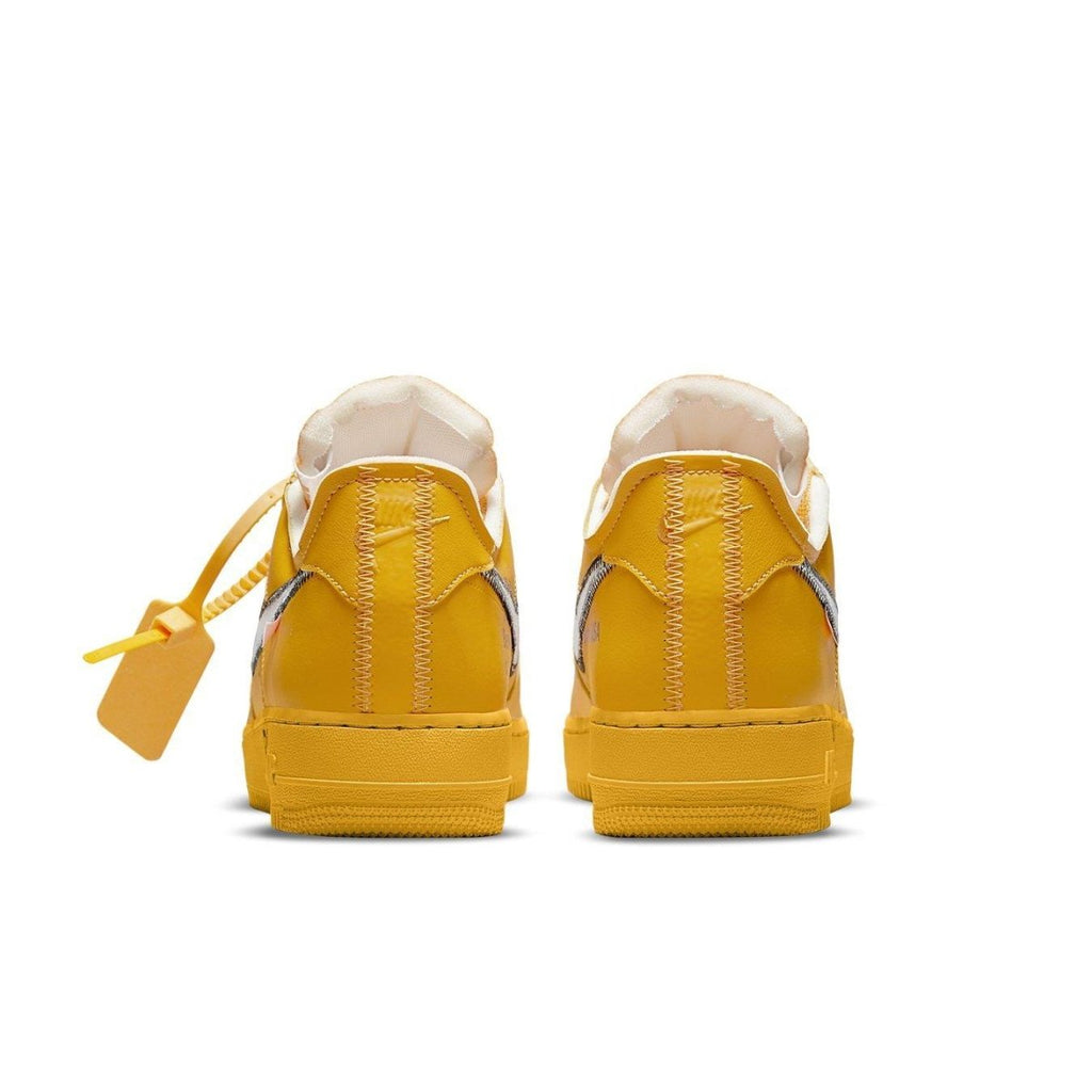 Back view of Nike Air Force 1 Low Off-White ICA University Gold sneakers with yellow leather and silver Swoosh.
