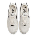 Nike Air Force 1 Low SP AMBUSH Phantom sneakers with unique design and AMBUSH branding in white and black.
