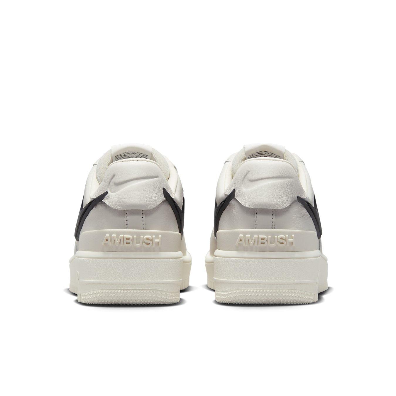 Back view of Nike Air Force 1 Low SP AMBUSH Phantom sneakers with black accents and embossed AMBUSH logo.
