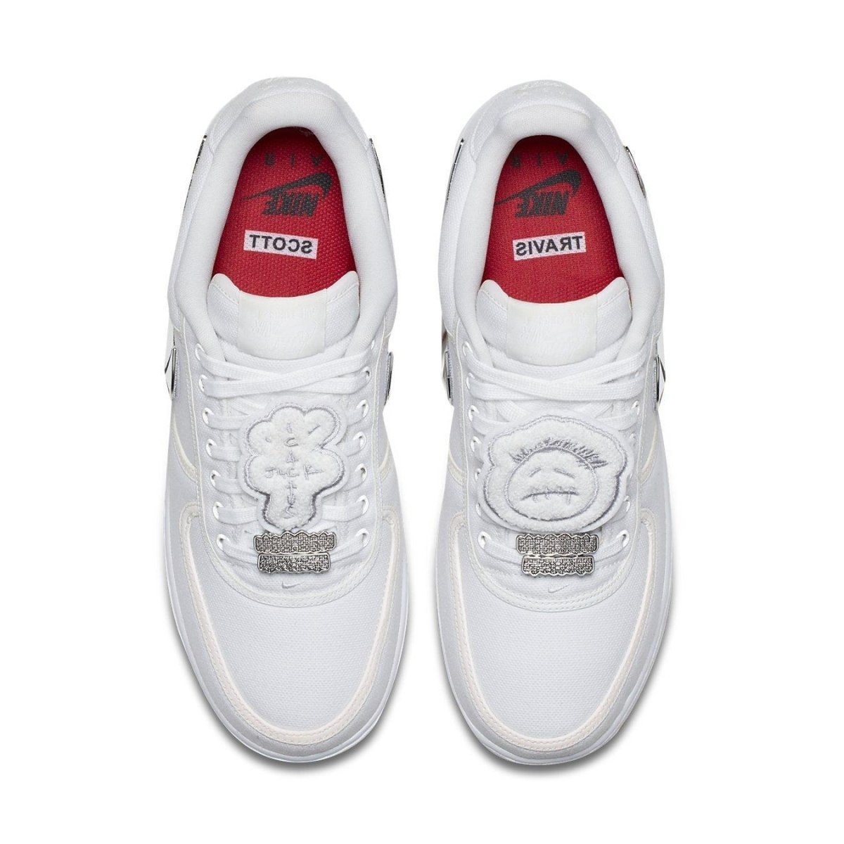 Nike Air Force 1 Low Travis Scott AF100 sneakers featuring unique embroidered patches and red accents.
