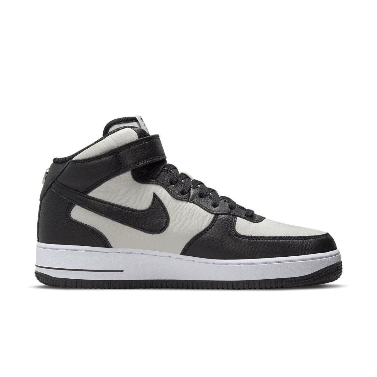 Nike Air Force 1 Mid Stussy Light Bone Black sneaker featuring premium leather panels in black and white.