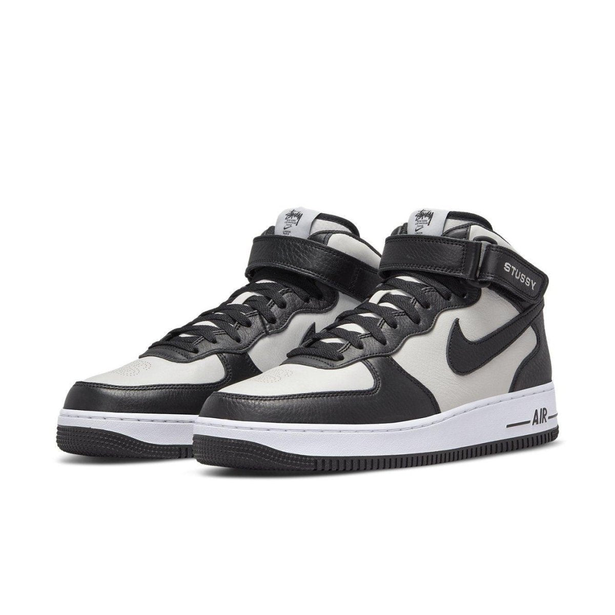 Nike Air Force 1 Mid Stussy Light Bone Black with premium leather panels in black and white.