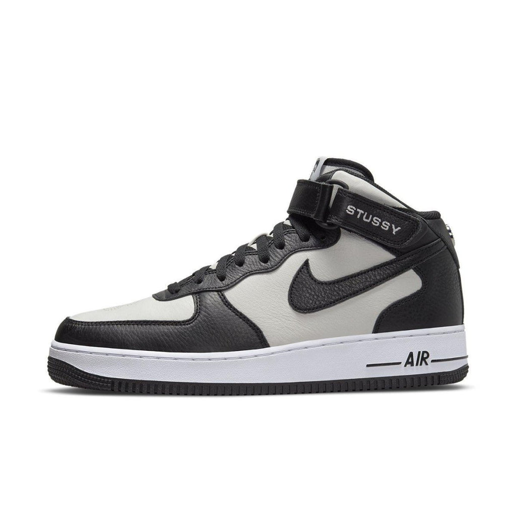 Nike Air Force 1 Mid Stussy in light bone and black with premium leather and stylish details.