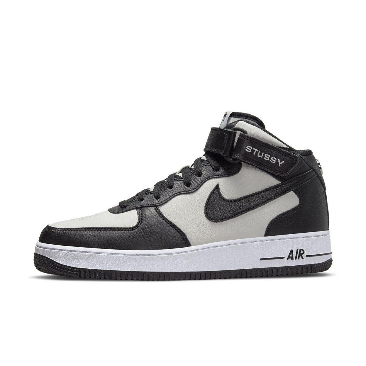 Nike Air Force 1 Mid Stussy in light bone and black with premium leather and stylish details.
