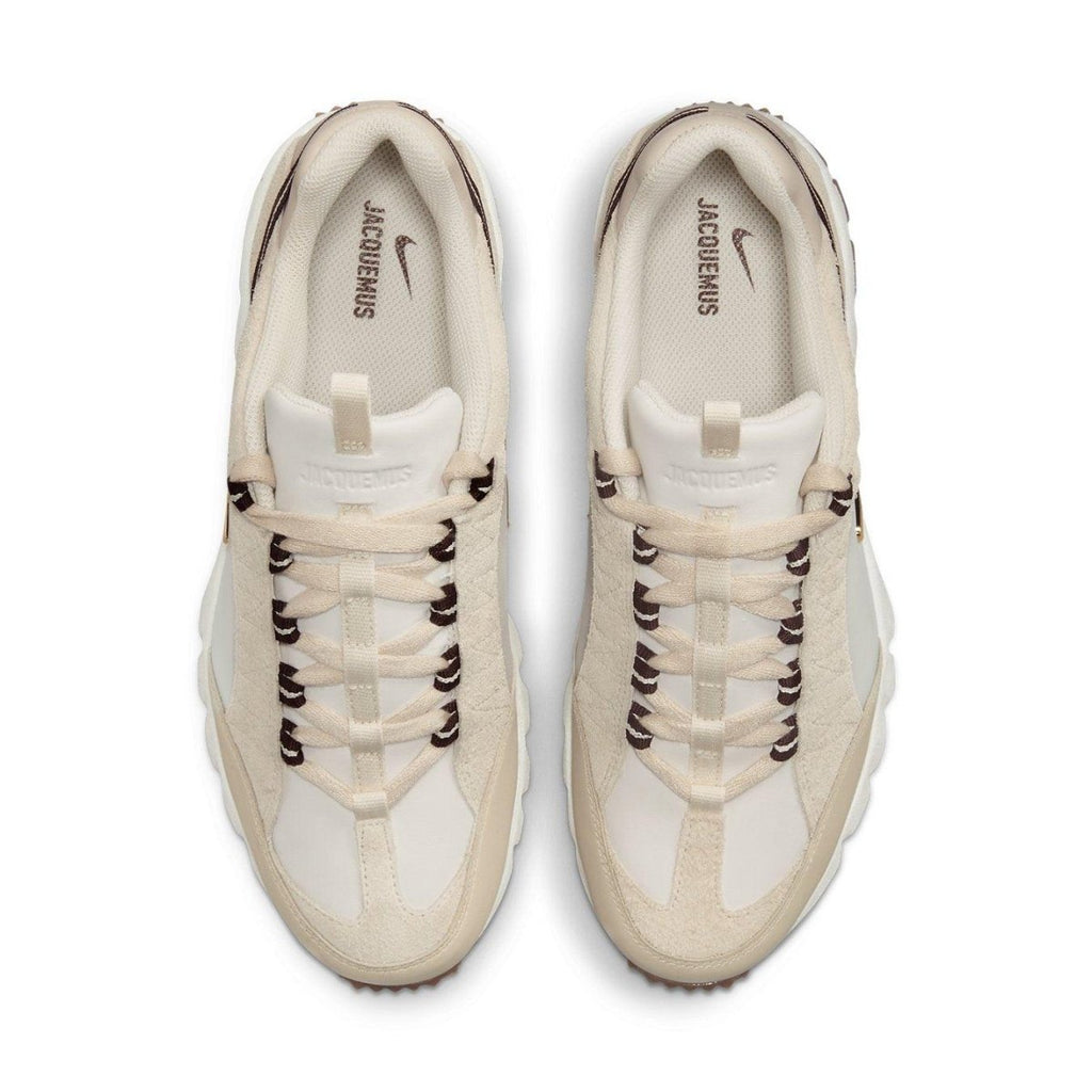 Nike Air Humara LX Jacquemus sneakers in light bone and gold with cream leather and suede overlays.