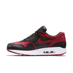 Nike Air Max 1 Bred sneaker in premium black and Varsity Red leather with a classic design.