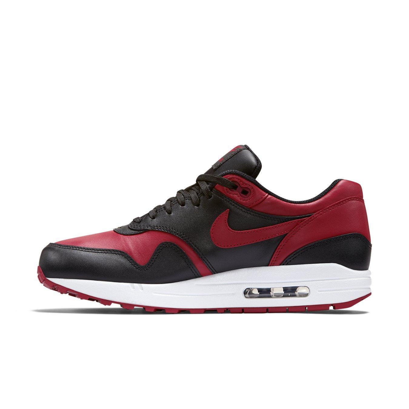 Nike Air Max 1 Bred sneaker in premium black and Varsity Red leather with a classic design.