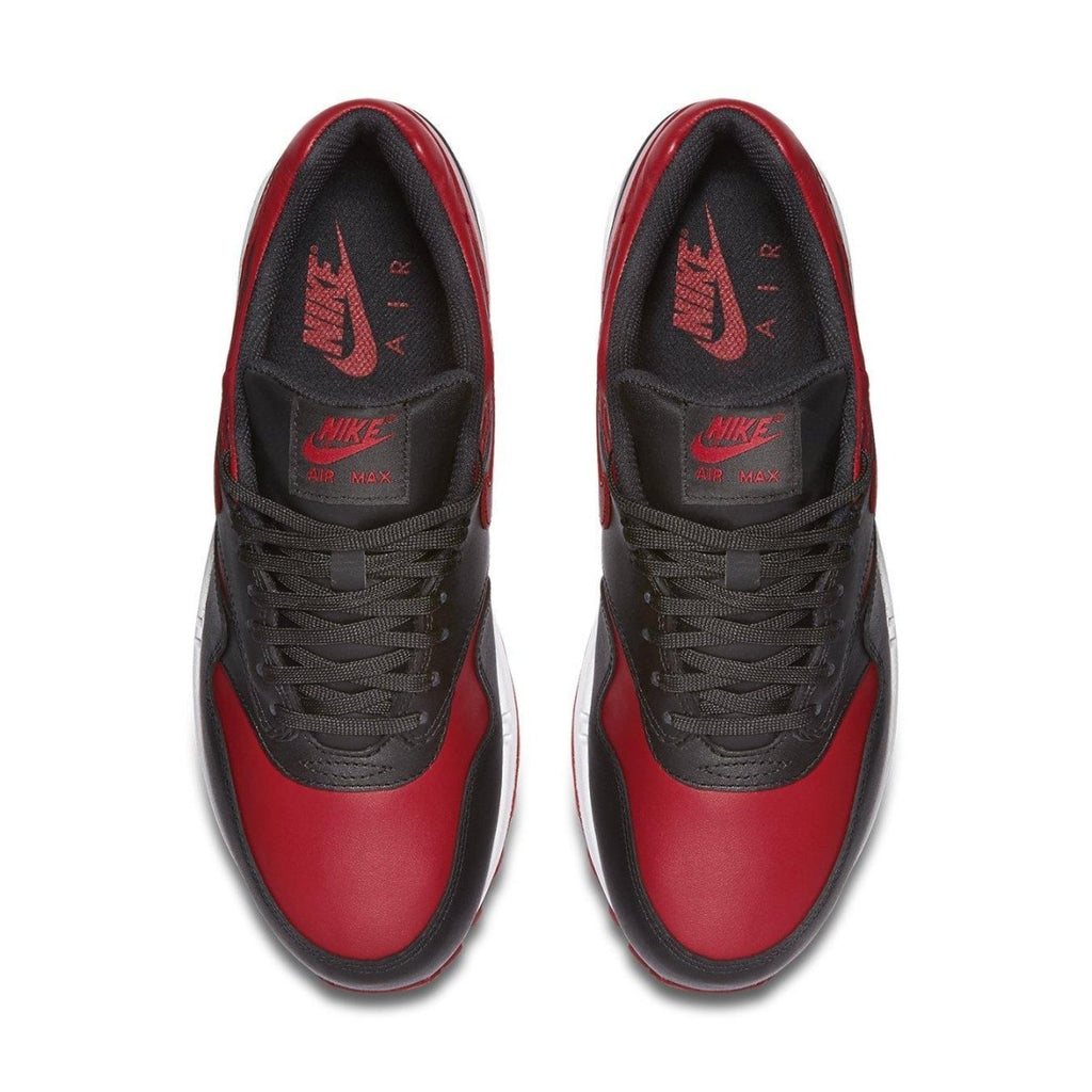 Top view of Nike Air Max 1 Bred sneaker in black and Varsity Red with brand logo.